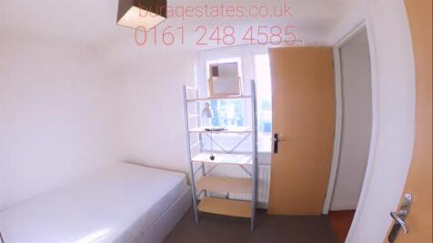 Bright, simply furnished bedroom with a single ...