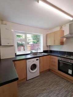 Well-presented fitted kitchen with light wood c...