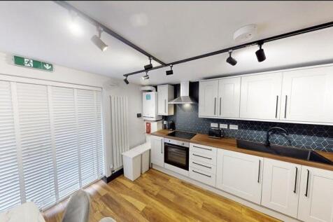 Bright modern kitchen with white shaker cabinet...
