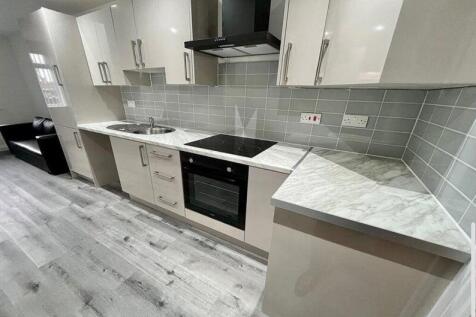 Modern fitted kitchen with glossy cabinets, int...