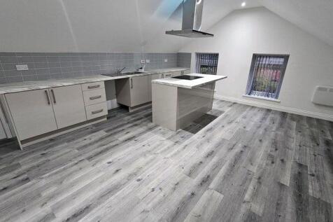 Bright, modern open-plan kitchen with a central...