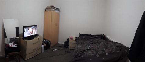 Simple furnished bedroom with a single bed, war...