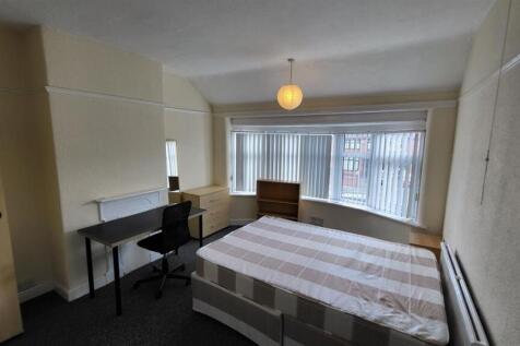 Bright double bedroom with a large front window...