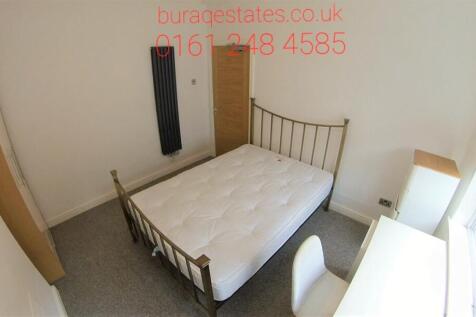 Bright, neutral double bedroom with a metal-fra...