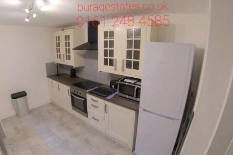 Bright modern kitchen with fitted cabinets, int...