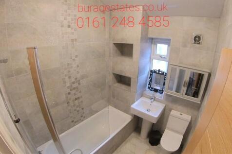 Modern bathroom with a bath and shower screen, ...