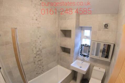 Modern bathroom with a bath and overhead shower...