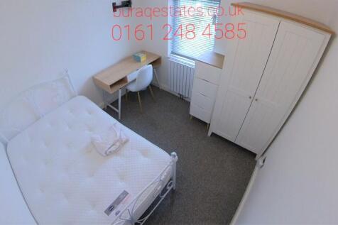 Bright, simply furnished small bedroom with a s...