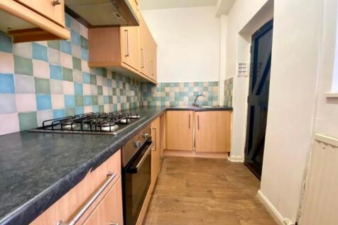 Bright fitted kitchen with modern wood-effect c...