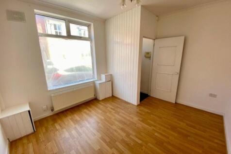 Bright, freshly painted bedroom with large stre...