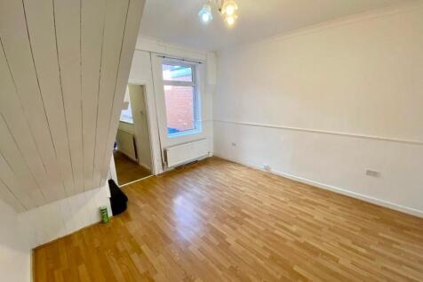 Bright, freshly painted living room with wood-e...