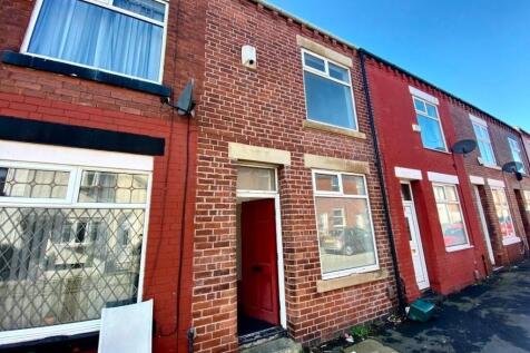 Traditional red-brick terraced house with stone...
