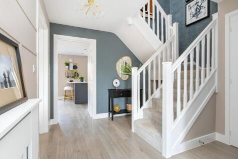 A welcoming entrance hall with feature staircase