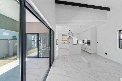 Light and spacious living area opening up onto the braai and pool area