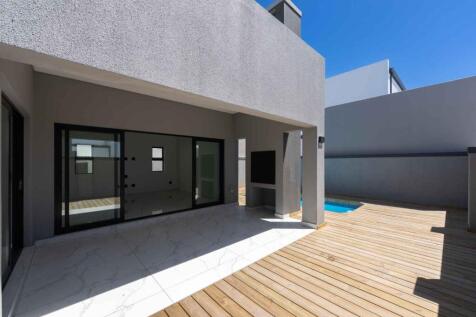 Spacious outside patio, deck with built in braai and swimming pool