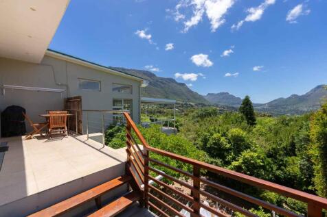 Two bedroom self-contained apartment with living areas and outdoor patio.