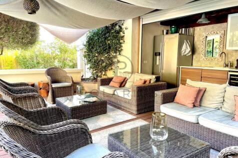 Cozy outdoor seating area with wicker furniture, c