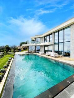 The image features a modern house with large glass