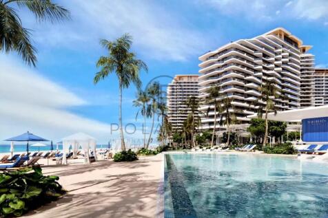 A beachfront resort featuring modern buildings, pa