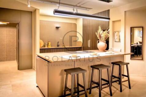 A modern kitchen interior featuring a central isla