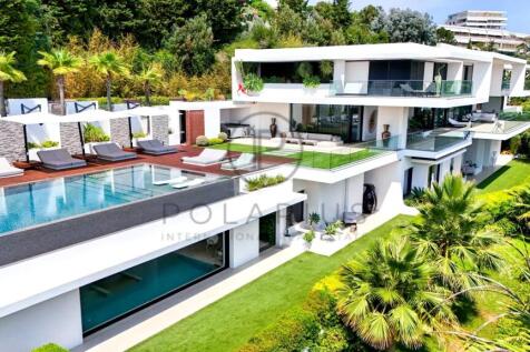 A modern, luxurious villa with an infinity pool, s
