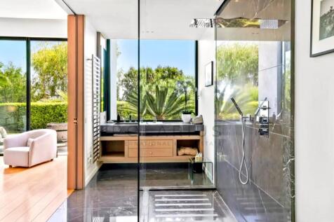 Modern bathroom with glass-enclosed shower, offeri