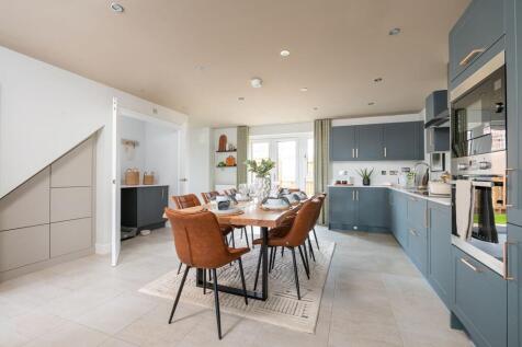 A spacious kitchen area with French doors leading to the rear garden