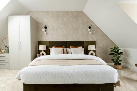 A showstopping main bedroom with tall ceilings
