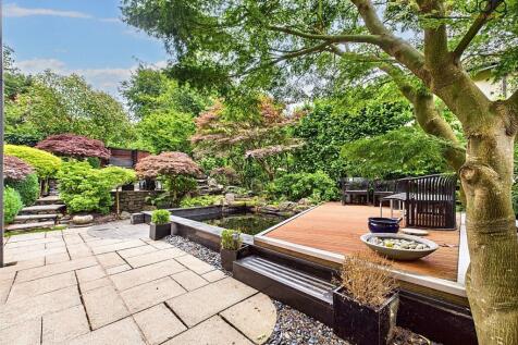 Coy fish pond and seating area with green views