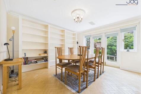 Spacious Dining Room with Built in Shelving and French Doors