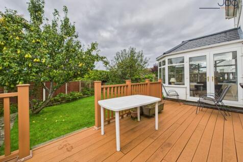 Spacious garden to the rear of the property with decking and fruit trees