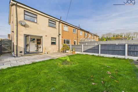 Generous garden combining lawn and paved areas, rear view of the property.