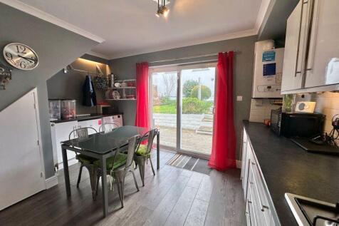 Open plan kitchen dining room with pa...