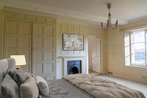Bedroom 1 with paneling and feature fireplace