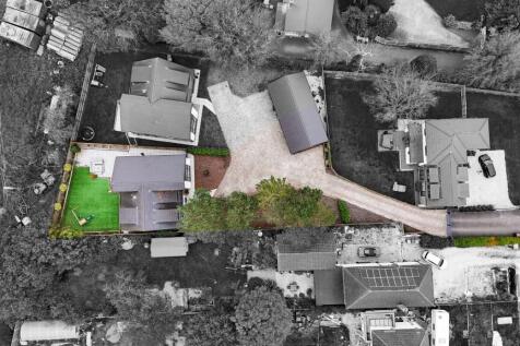 Set back from the main road behind electric gates