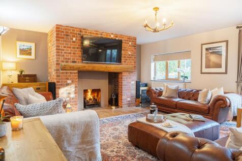 Rear lounge with large open fire