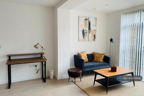 Living Area With Desk, Sofa And Coffee Table