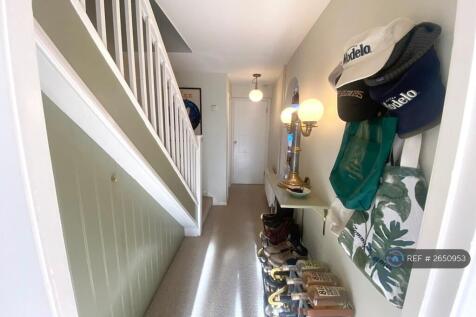 Hallway Featuring Under Stairs Storage