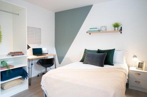 Bright and welcoming master bedroom featuring a...