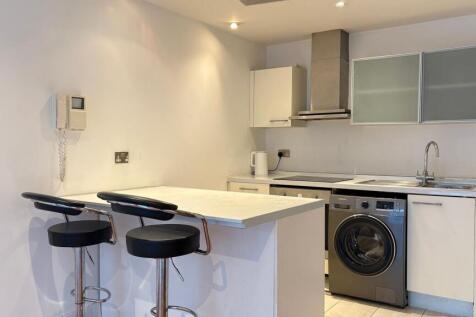 Modern kitchen with breakfast bar and appliance...