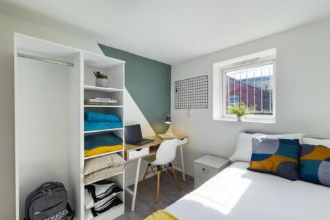 A bright and tidy double bedroom featuring a st...