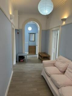 Bright and airy hallway with charming archway...