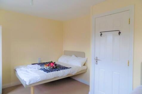 A bright and tidy double bedroom featuring a ne...
