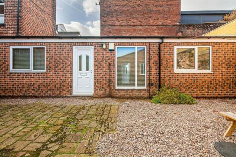 Private outdoor space with paved seating area...