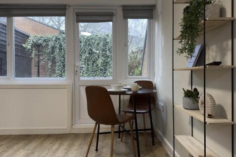 Bright eat-in kitchen area with a small round d...