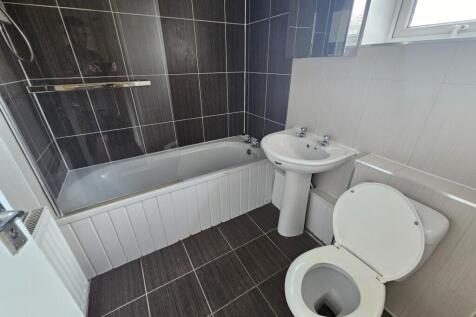 A clean and well-maintained bathroom with a bat...