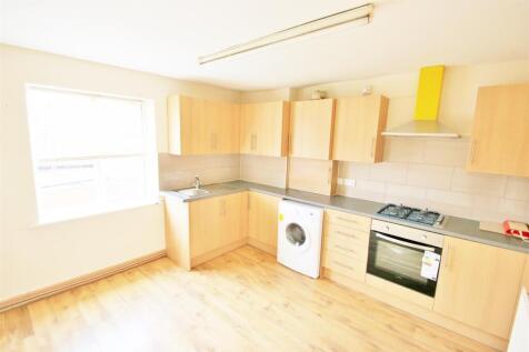 Bright, tidy kitchen featuring ample cabinetry,...