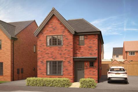 A modern brick house with manicured hedges in the foreground sits on a street with other houses and