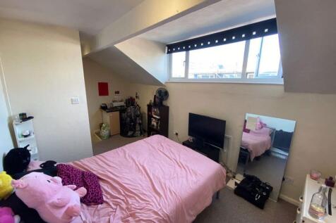 A bright and cozy bedroom with a comfortable do...