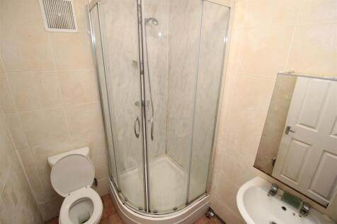 Bright and tidy bathroom with glass shower cubi...